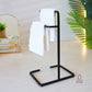black towel stand for bathroom, modern hand towel holder, countertop towel rack, minimalist towel stand India, matte black towel holder, freestanding towel stand, bathroom accessories modern, small towel stand for sink, powder-coated towel rack, towel organizer for vanity.